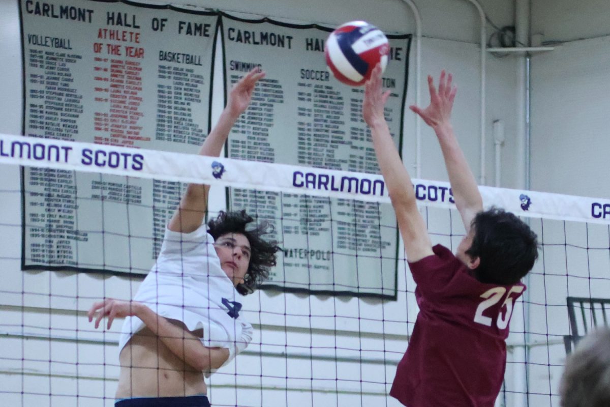 Freshman Dylan Sorensen uses one hand to hit the ball over the net. With appropriate timing, the Menlo-Atherton blocker was able to deflect the hit, bringing the ball back onto the Scots side of the court. The Scots kept the ball alive and continued their attempt to score a point.
