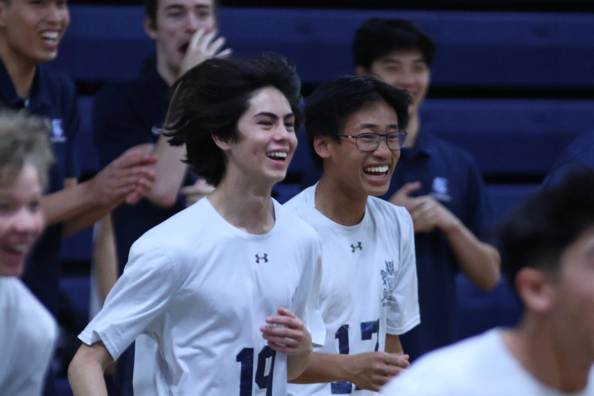 Freshmen Trevor Nelson and Orion Gurskis happily run onto the court after the Scots score their final point to win the game. The players congratulated each other as their hard work had paid off. The Scots beat the Bears 2-0, winning the first set 25-6 and the second set 25-15. 