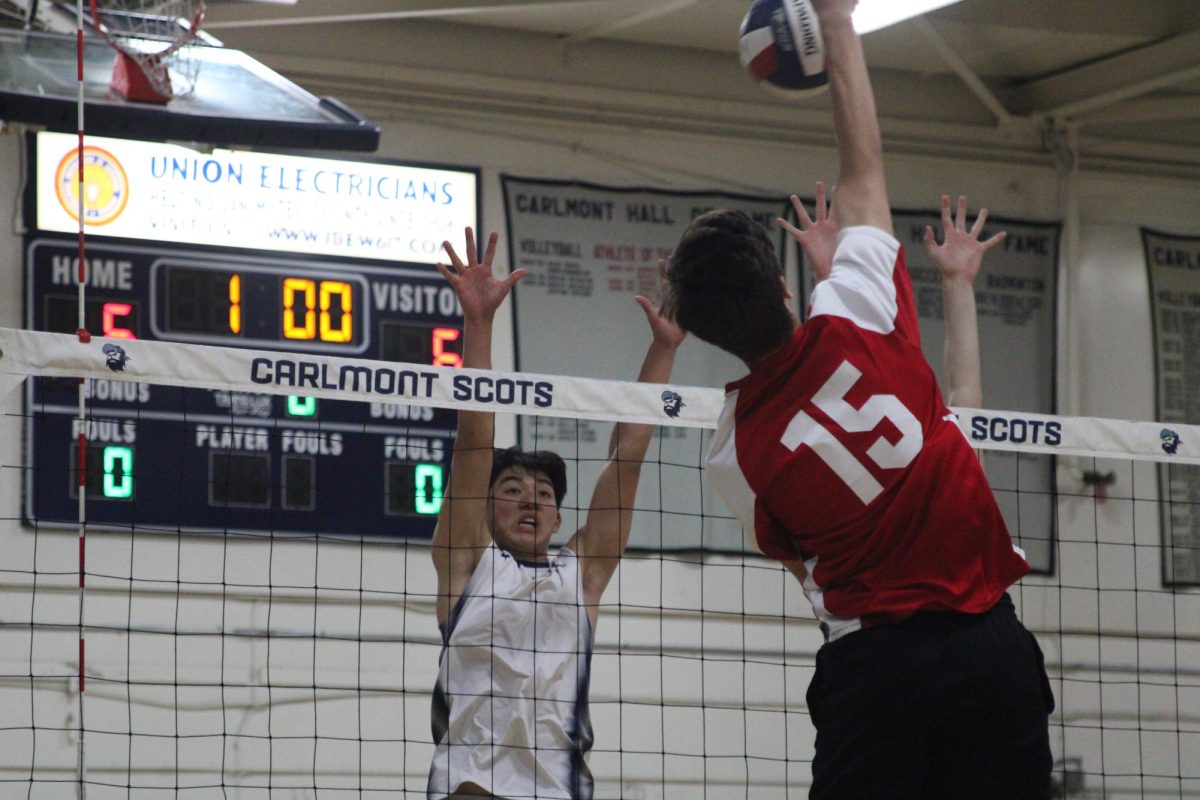 Seniors Kevin Tomita and Devin Engberg jump to block a spike from the Panthers. They blocked the shot and were able to score a point. Many of the Scots players are very tall and athletic, which has helped their team achieve success throughout the season.