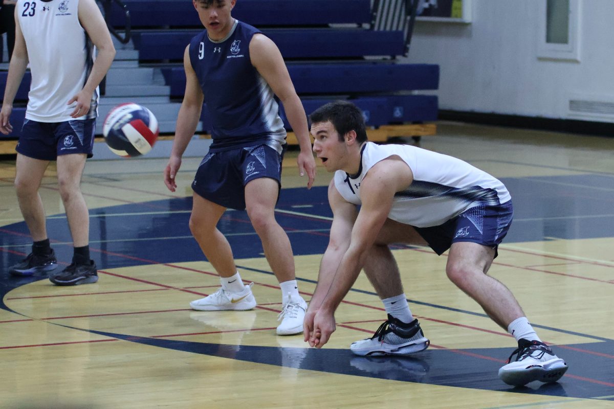 Senior Alex Ievers bends down to bump the ball. He kept the ball in play, giving the Scots a chance to score. The Scots demonstrated good team chemistry and cohesion throughout the game as they worked together to score. 