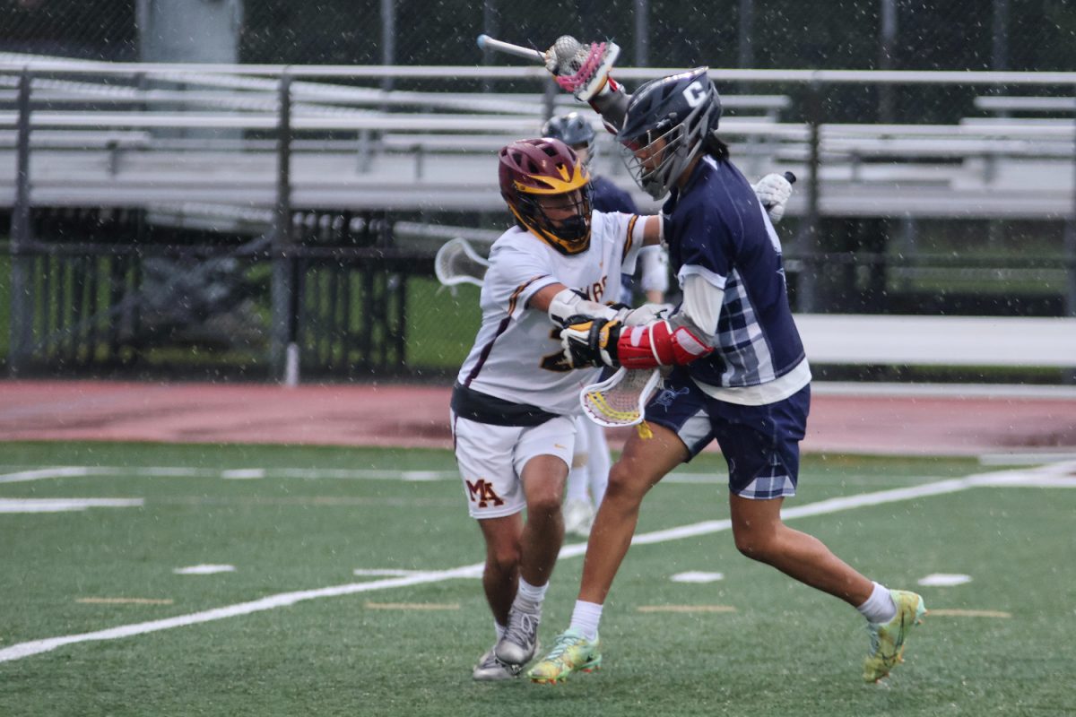 Senior Jacob Tom performs a swim dodge in an attempt to get past the defender. This move helps players beat their defenders with a smaller risk of getting the ball hit out of their stick. During the game, Tom made this move several times with success. 