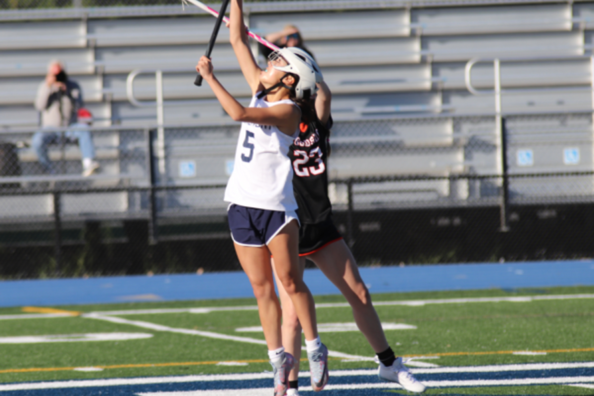 Sophomore Lindsay Wong jumps high to secure the ball for her team from a face-off. She captured the ball and ran forward, but ultimately, the Scots were not able to convert the opportunity.