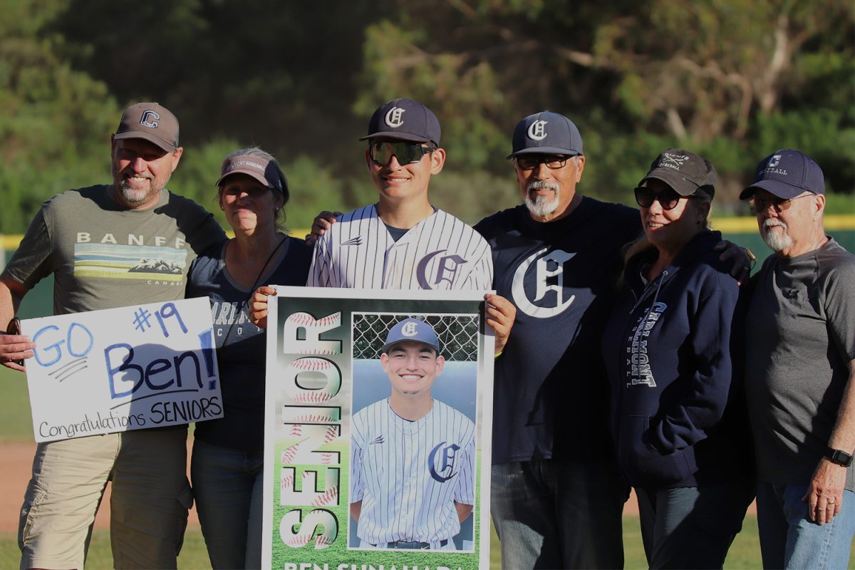 Senior Ben Sunahara poses with his family for a photo after the game. To celebrate his senior night, Sunahara’s family made posters to show their support. Several other families of seniors made posters to celebrate this occasion.