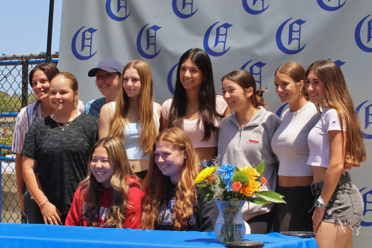 The girls varsity softball team gathers around their teammates, Won and Rouspil. During the senior signing ceremony, several family members and friends came to support and congratulate the commitment of these seniors. It was an emotional time of recognition for these nine seniors who will go on to play a sport for their college.