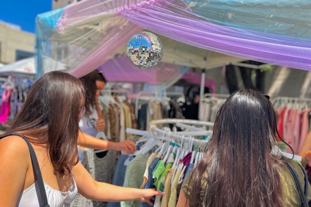 Shoppers search through racks of vintage clothing at a booth. The So-So Market is very curated, which is why I like it. You don’t have to work that hard to find something good,” said Rabiah Kabir, a regular shopper at the So-So Market.