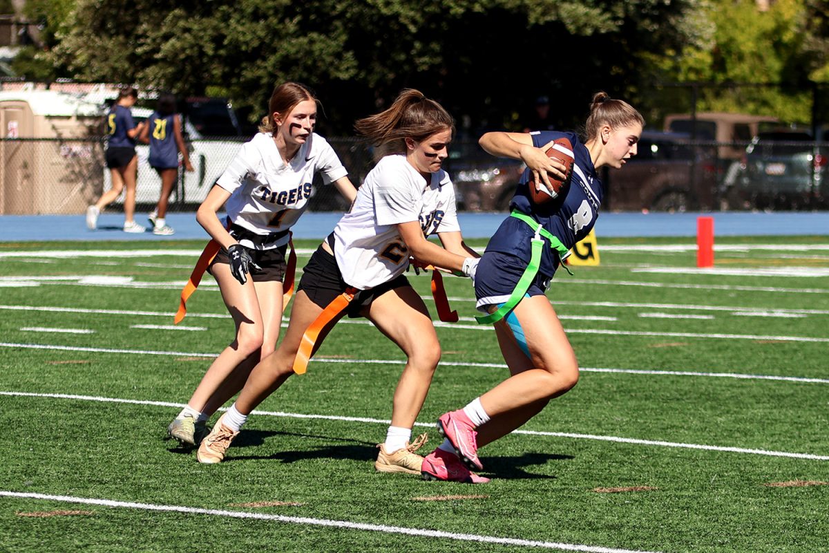 Several Notre Dame defenders chase after senior Gabriela Cole as she runs toward the end zone. Cole caught two interceptions during the game, one of which she was able to run in for a touchdown. Her presence in defense and offense proved her to be an influential member of the team.