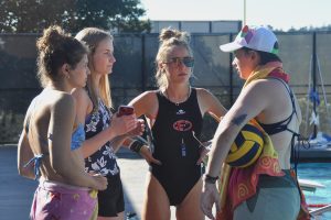 Ciera Stratton, Hunter Crawford-Shelmadine, Allegra Ferme, and Megan Olazar prepare for practice while the players warm up. In their discussion, they outlined what each of them will do with different groups of players. Their primary focus is getting ready for their first game of the season. 