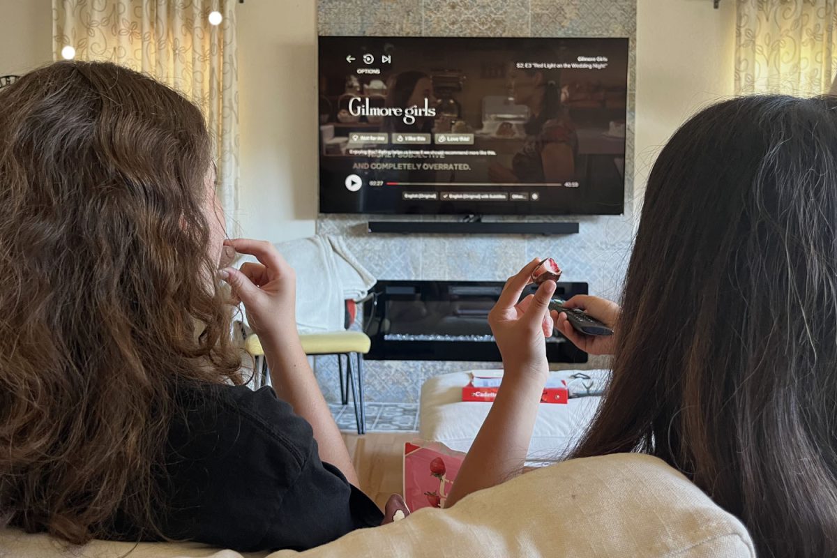 Junior Reese Adrouny sits down on her couch, prepared with her favorite snacks, and puts on "Gilmore Girls" with a friend. "Gilmore Girls" is an American comedy-drama set in a small town in Connecticut that explores the lives of Lorelai and Rory Gilmore.  