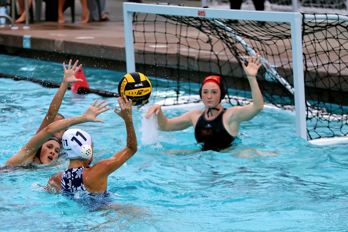 Farrell attempts to place the ball in the back of the net. Several Menlo Atherton players dove to block the shot, including the goalie. The ball barely missed the inside of the goal, bouncing off of the post.