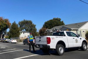 A police officer guards where the fire occurred a few hours after firefighters put it out. The cause of the fire and the safety of the residents in the area remains unknown.