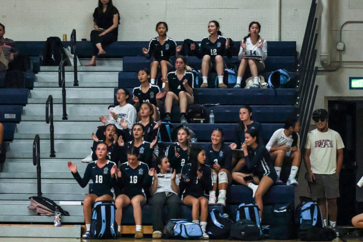 The JV volleyball team cheers from the stands, supporting the varsity team as they play. The cheering helps bring life to the atmosphere of the match and keeps the spectators engaged in the game. Many JV team members stay after their game to cheer on their varsity team, enforcing a tight community among both volleyball teams.