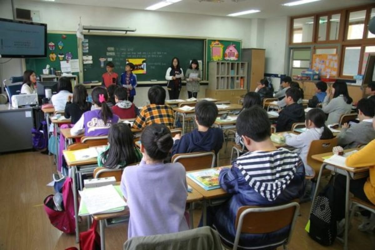 Young school children sit in a classroom at a lesson. Many worry that the incorporation of religion into elementary schools especially puts students at risk of indoctrination or does not expose them to different cultures from an objective standpoint.