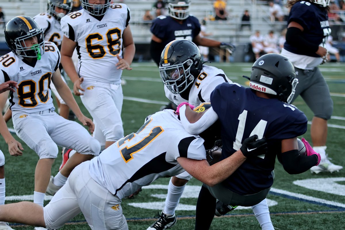 Freshman Julius Reyes runs the ball and gains yardage for the Scots before getting tackled. Reyes fought for every yard he gained while being surrounded by Terra Nova Tigers. Later on this possession, Carlmont scored their final touchdown of the game. 
