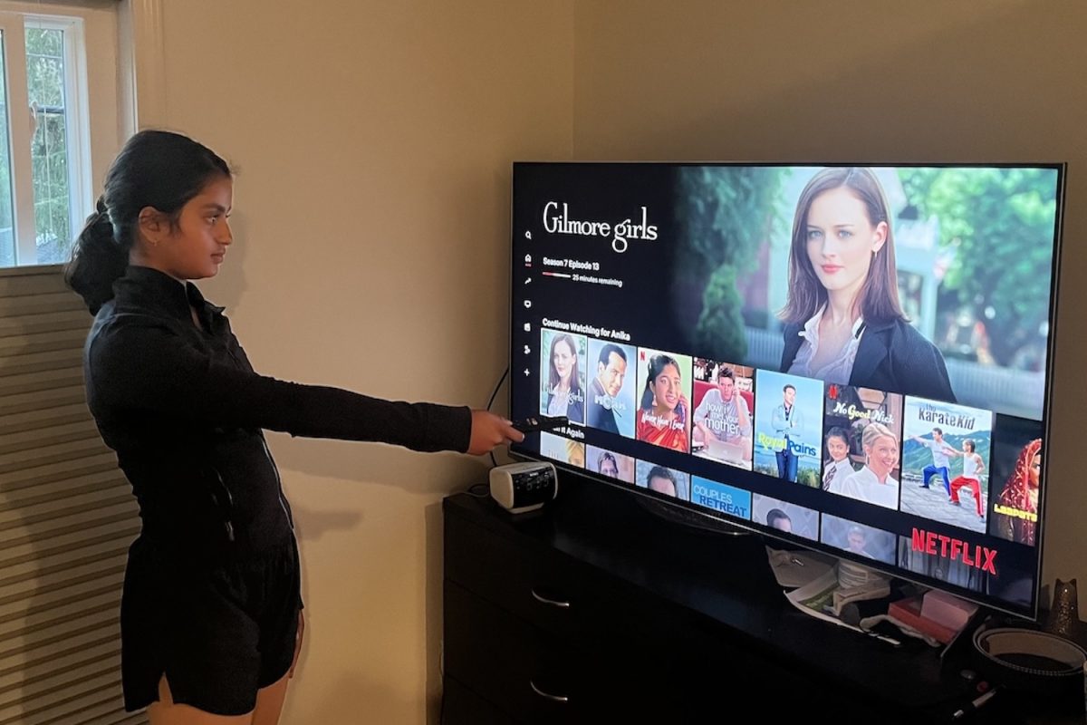 A teenage girl scrolls through Netflix, looking for a show to watch. After going through their favorite shows, many teens face the problem of not knowing what to watch.