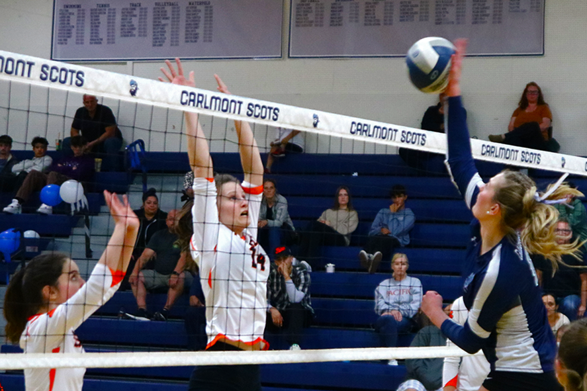 Carlmont senior Annika Snow spikes the ball over the net and hopes to score a point. Carlmont capitalized off of these opportunities and took a 23-18 lead late in the fourth set. 