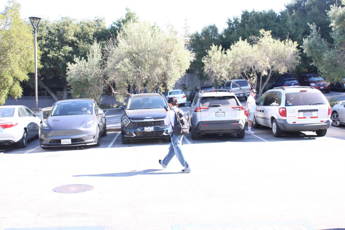 Chloe Chu holds an electric fan in front of her face as she walks to her mother's car to get picked up. Temperatures that day reached a high of 85 degrees.