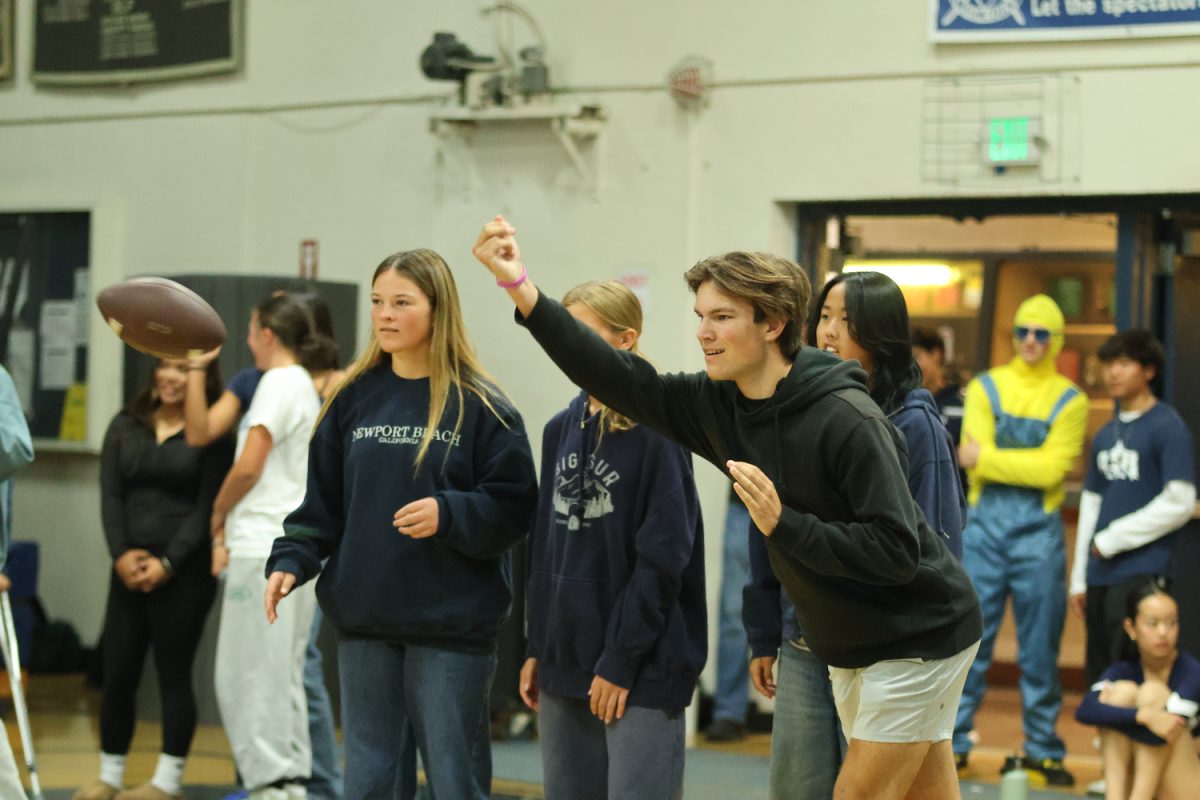 The girls flag football team recruits students to participate in a football-throwing competition. 