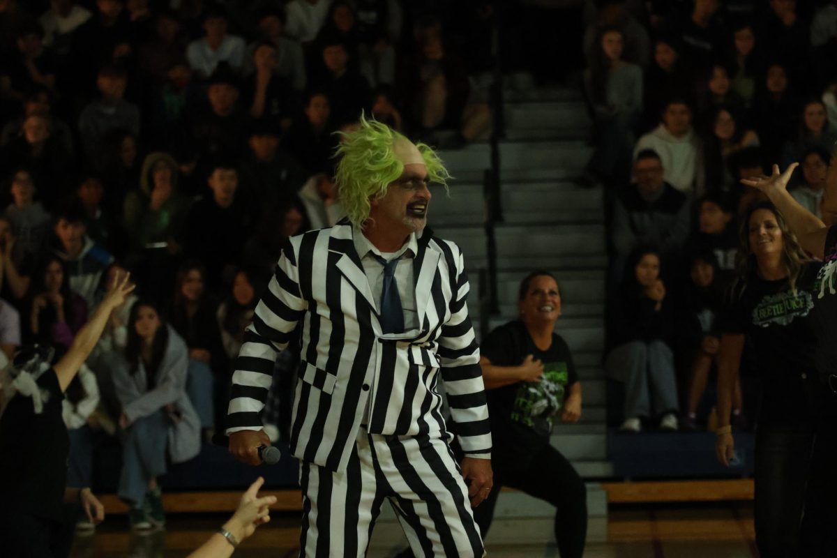 Activities Director James Kelly shocks the crowd during the staff dance performance in a spooky Beetlejuice costume.