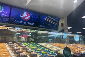 Mountain View's Krispy Kreme is selling their freshly made Ghostbusters promotional donuts. As the lights overhead change the color of the icing on the new Slimer donut from purple to blue.