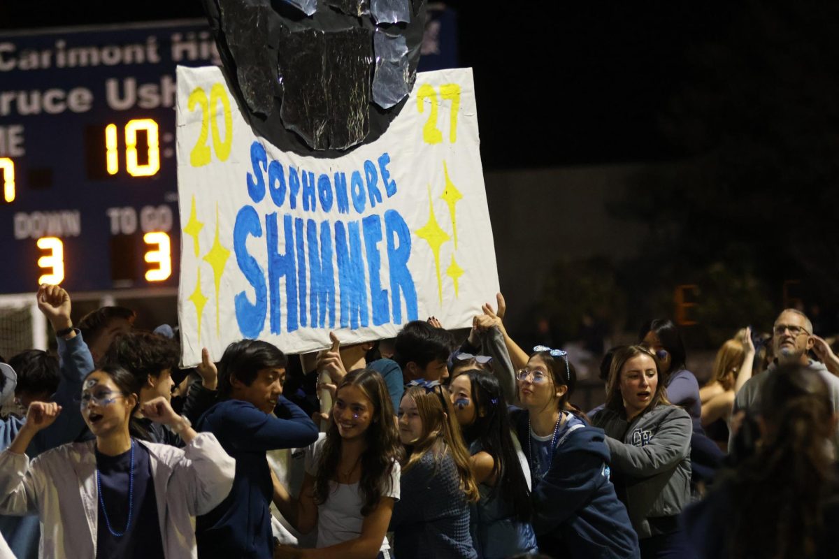 The sophomore class carries their float across the track during halftime.