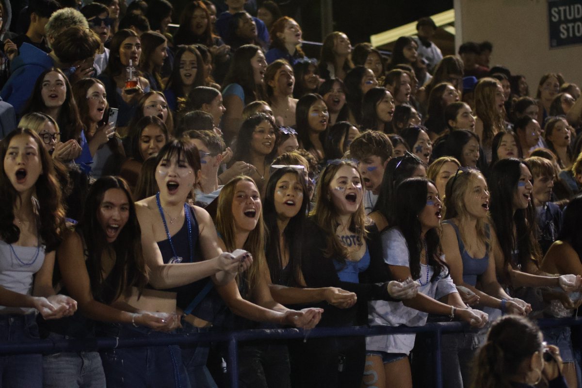 Members of the Screamin' Scots student section countdown the seconds until the game's third quarter.