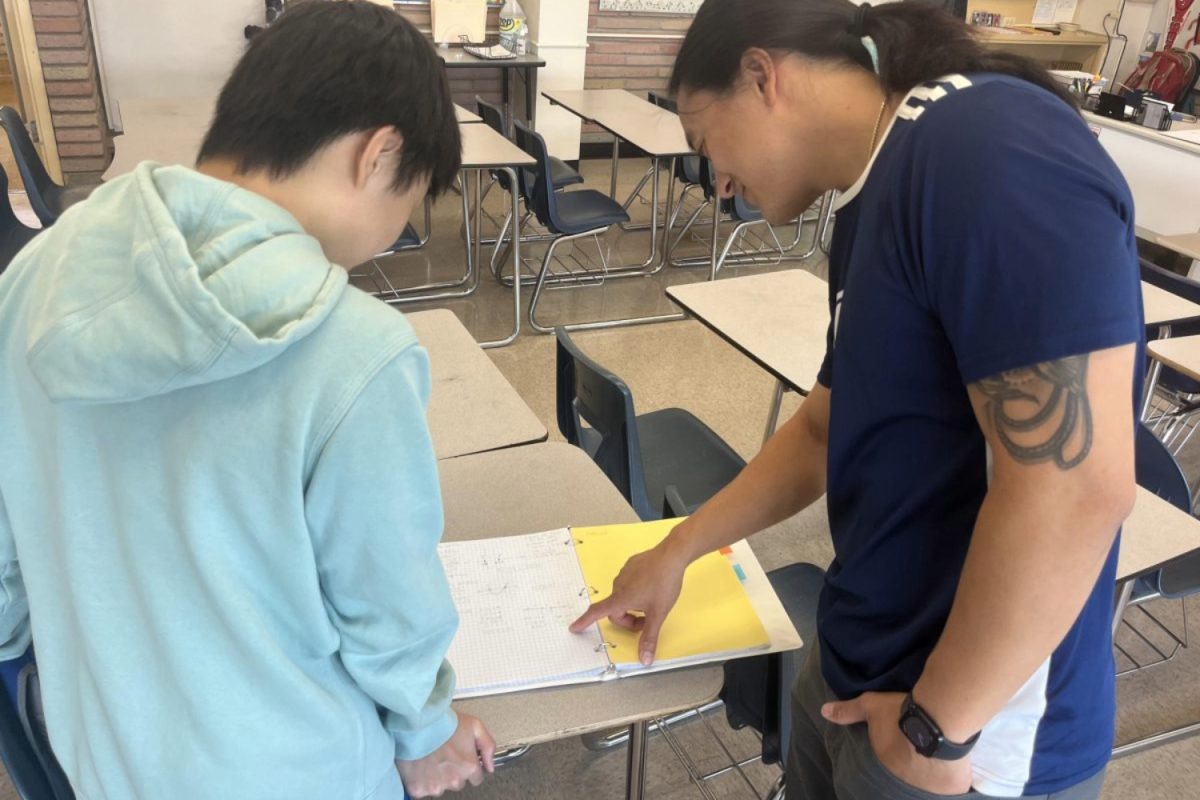 Dan Nguyen helps a student with their assignment. "I’ve loved interacting with the students," Nguyen said. "I love being able to build relationships between students and other students, students and myself, and seeing how those relationships can affect learning."