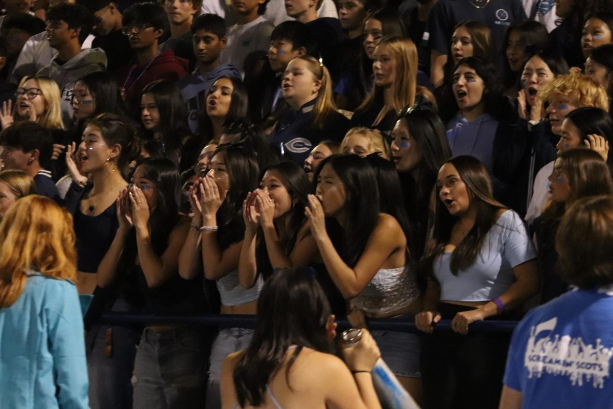 The student section gets loud as they cheer on the football team. 