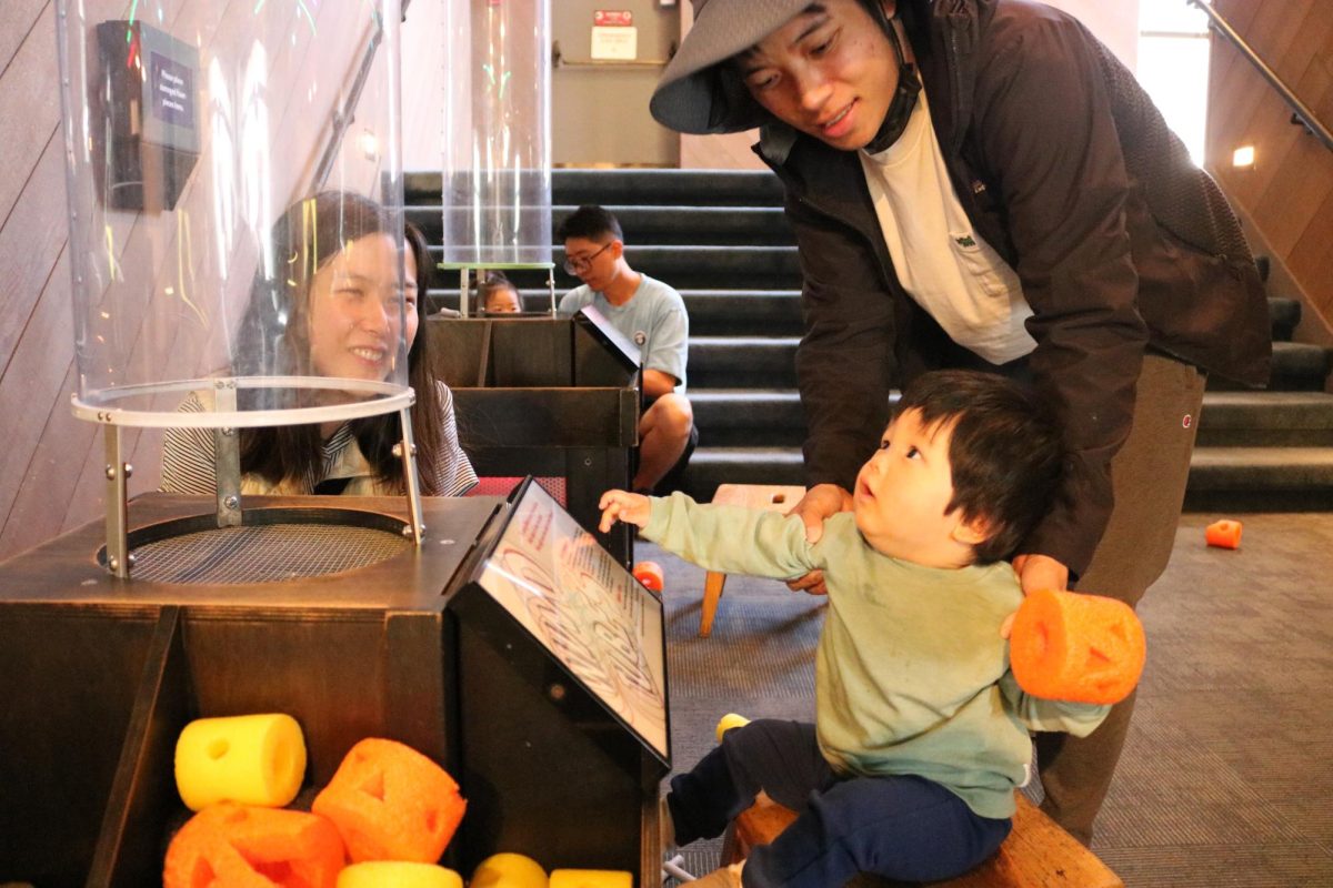 A family interacts with CuriOdyssey's Wind Tube during the "Fall into Science" event. Staff spend hours cutting out faces in the foam that float in the tunnel, but they feel that their work is worth it. "We're always trying to add and expand to our offerings. It's our sincere hope that visitors will continue to find new experiences to enjoy," said visitor engagement supervisor Molly Hicks.