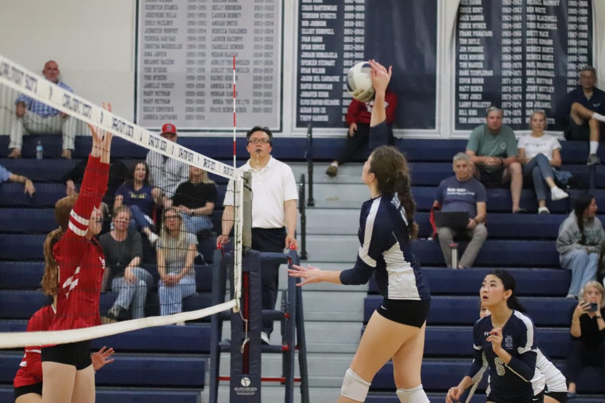 Olivia Pasion rises far above the net for the hit. The defense was late and couldn't block her shot, giving her a better advantage. Her teammates were relieved as there was no chance for a block.