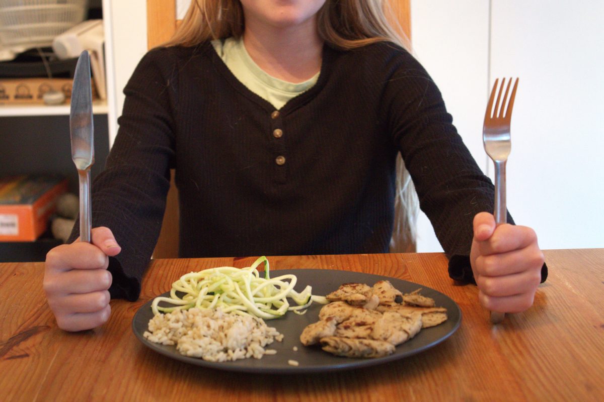 A student enjoys a plant-based meal which includes rice, vegetables, and plant-based chicken. "For the clients I work with, vegans, vegetarians, omnivores, it looks different for every person. It's different based on their their culture. It's different based on how they were raised. It's different based on their likes and dislikes," said Michelle DeWolf.