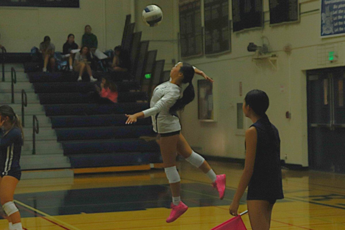 Carlmont libero Madeline Ho launches a powerful overhand serve.