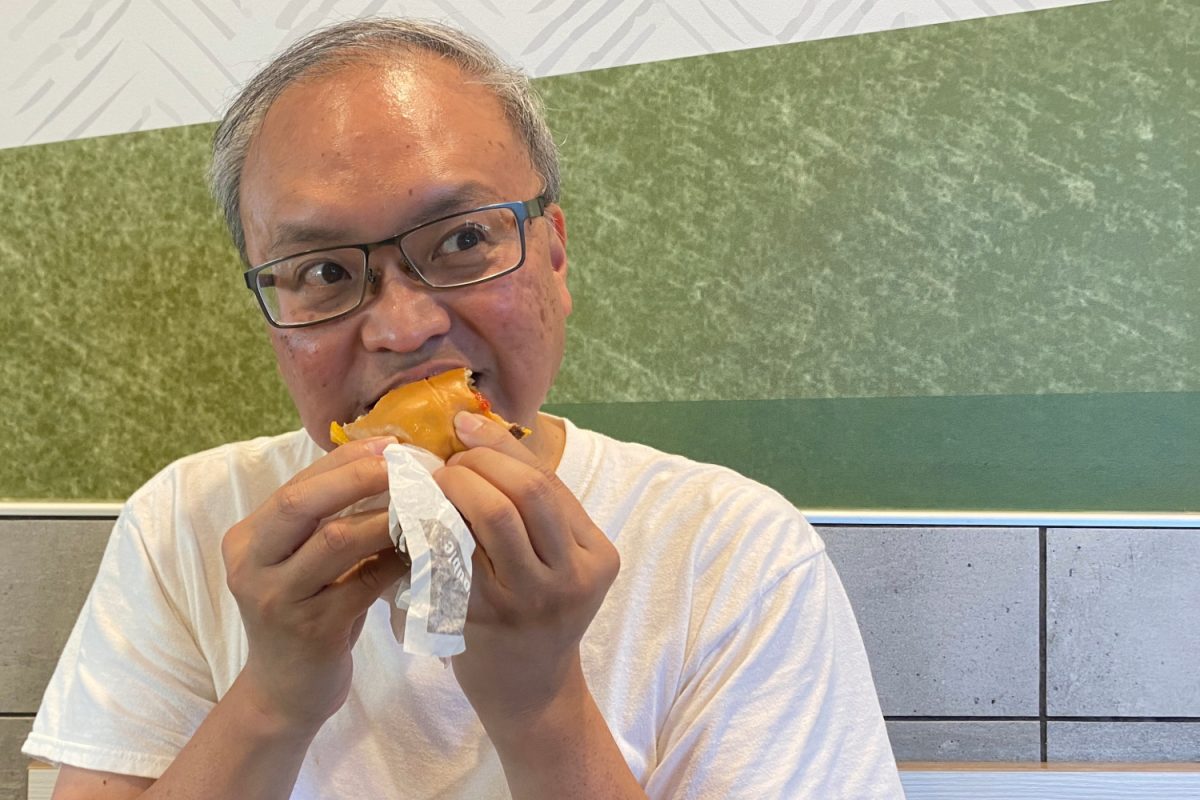 A customer at McDonald's eats a burger with caution. With the temporary removal of Quarter Pounders in several states, more people are becoming concerned with the quality of the food that is being served.