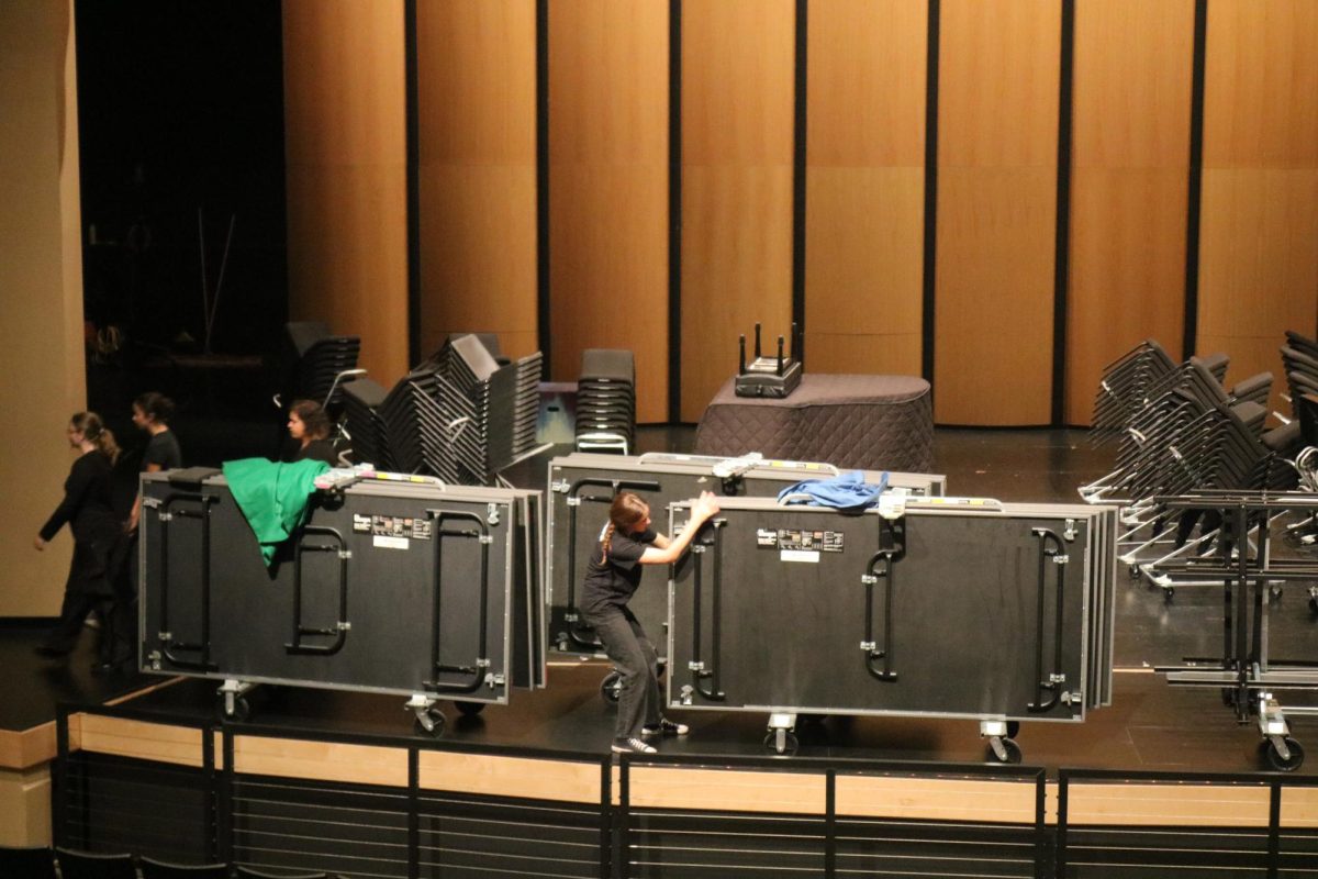 CTTA removes the risers after the choir concert at the Performing Arts Showcase. The showcase featured performances from Symphony Orchestra, Drama, Advanced Dance, and Choir.