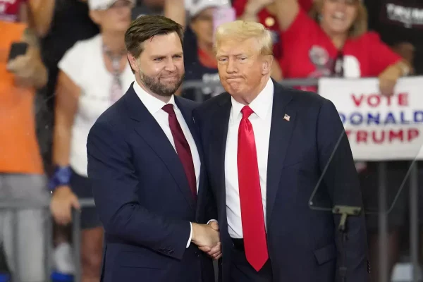 Donald Trump shakes hands with JD Vance. Vance, an Ohio senator, was selected as his running mate on Jul. 15. 