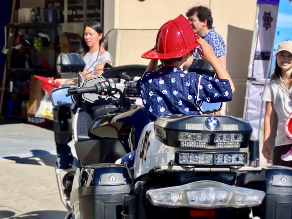 Children try out police motorcycles to learn about life in emergency services. 