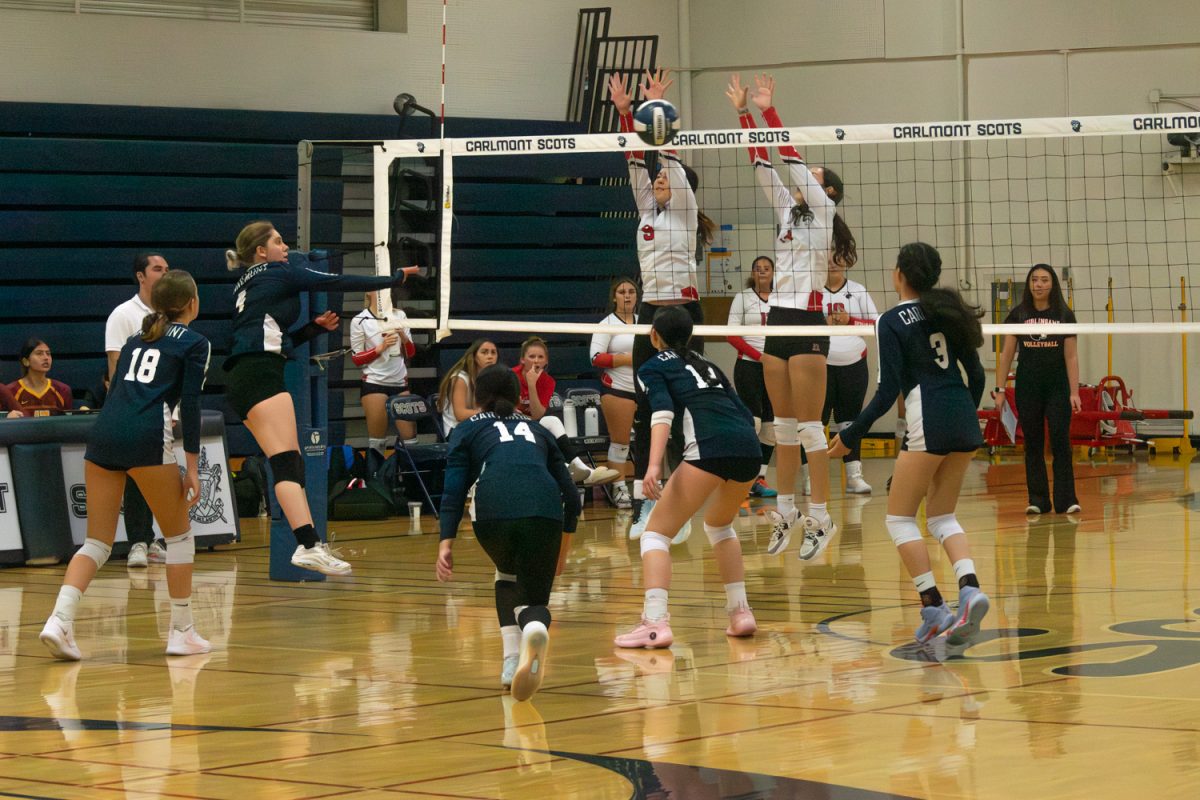 The Scots try to save the ball after the Panthers block a spike. One necessary area of improvement for the Scots is the ability to finish points at the net. In combination with the Panther's good defense, the Scots, in the end, weren't able to win the match.