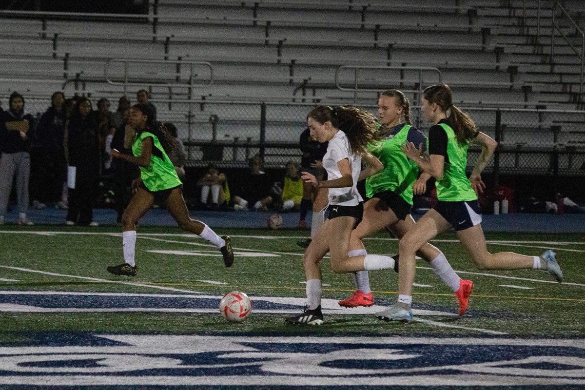 Freshman Lauren McLinden drives the ball down the field. Two defenders chased behind her for the ball, but she managed to get in front and cut them off. Being able to use your body to protect the ball is an important part of the game. 