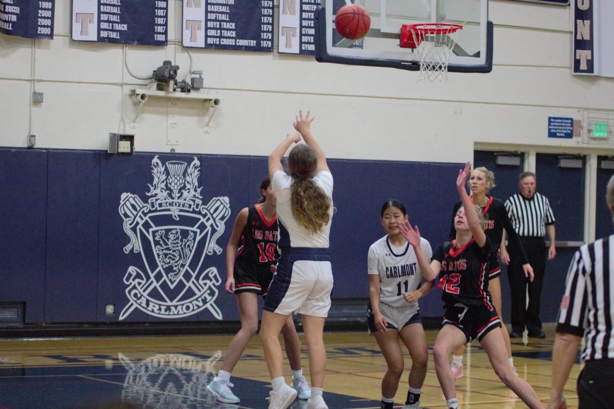 Freshman Chloe Luscri shoots a 3-pointer with seconds left on the shot clock. Teammate Alice Richez moved to block opponents from defending her. If time runs out on the shot clock, the opposing team will gain possession of the ball.