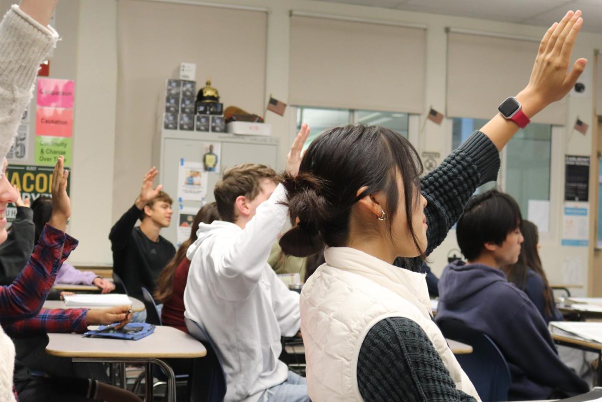 Students in Jayson Waller's AP U.S. History class raise their hands after discussing an open-ended discussion question with their peers, now ready to share their thoughts with the rest of the class. Waller doesn't typically give much agency to student volunteers as he prefers to put students on the spot to ensure each get relatively equal opportunity to speak.