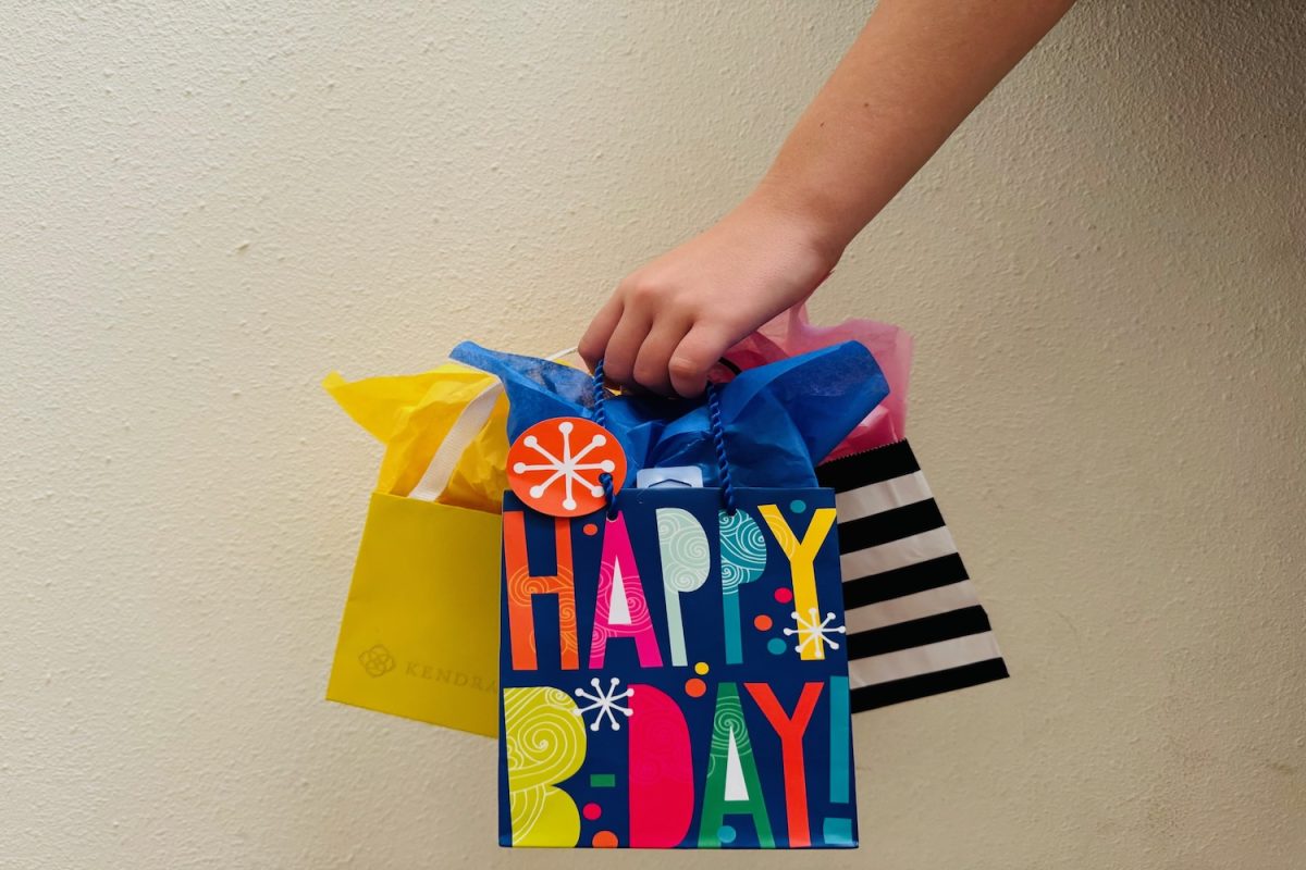 A student takes home their birthday freebies from Sephora and Kendra Scott.