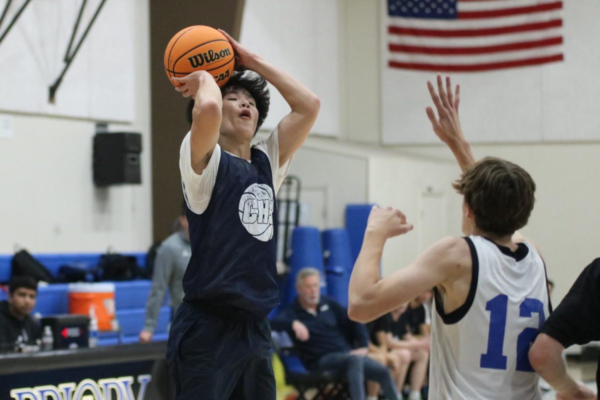 Senior Camden Ngo rises above the defender for the 3-pointer. His deep shooting helped him draw defenders outside of the paint as they have to guard him from even further. Having a consistent shot is important as a guard.