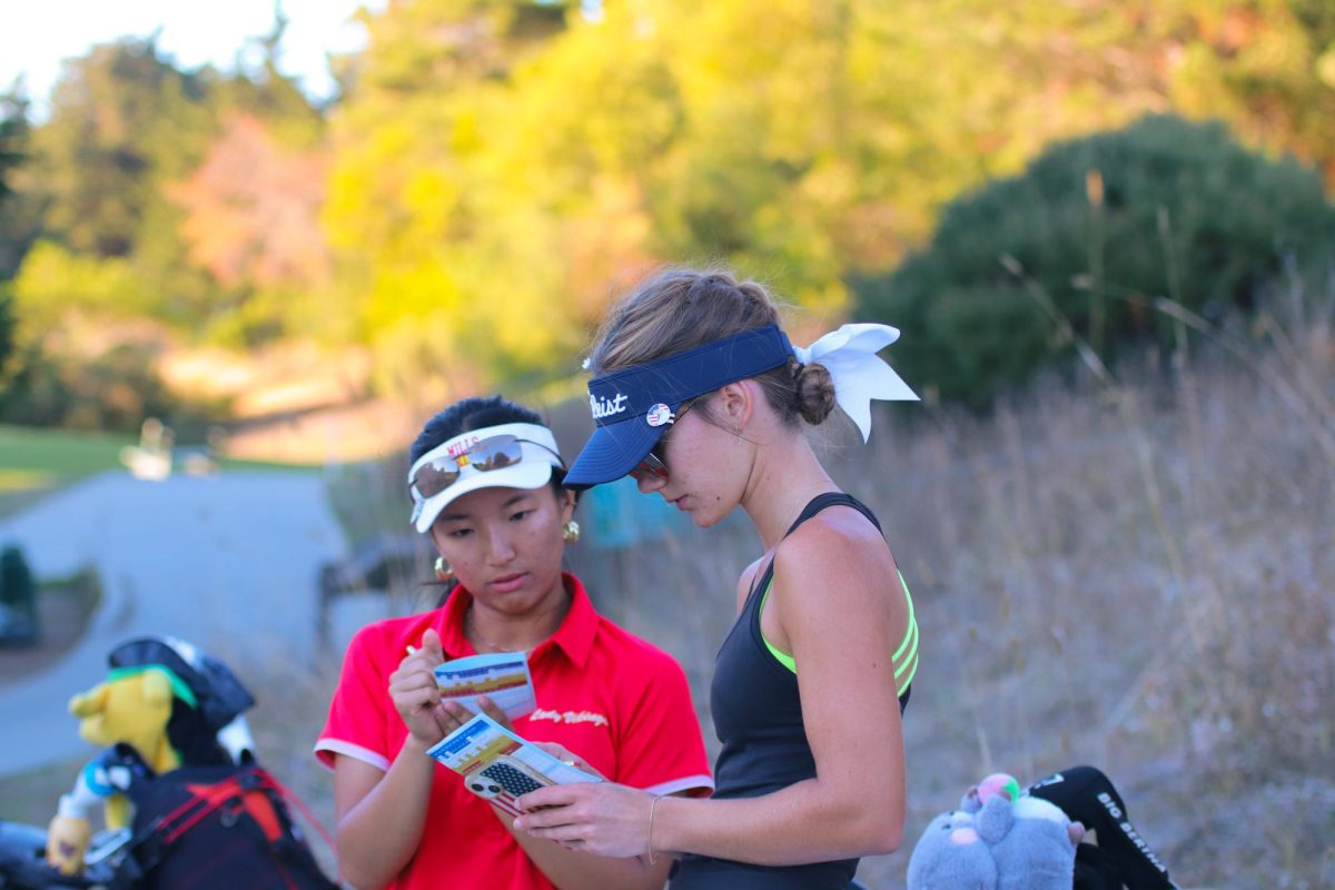 Molholm checks her score with her opponent. They keep each other's score to keep them honest with their scores. At the end of the match they go over their scores to make sure everything lines up. 