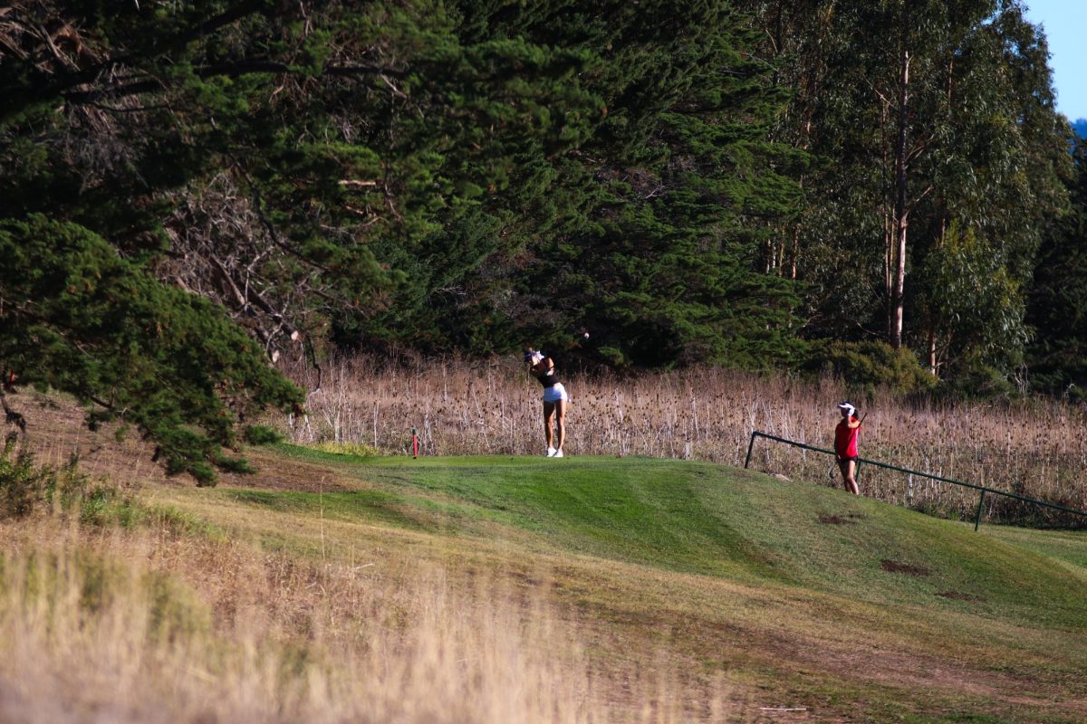 Molholm tees off as her opponents watch. Good tee shots are important to maximize the chances of success. 