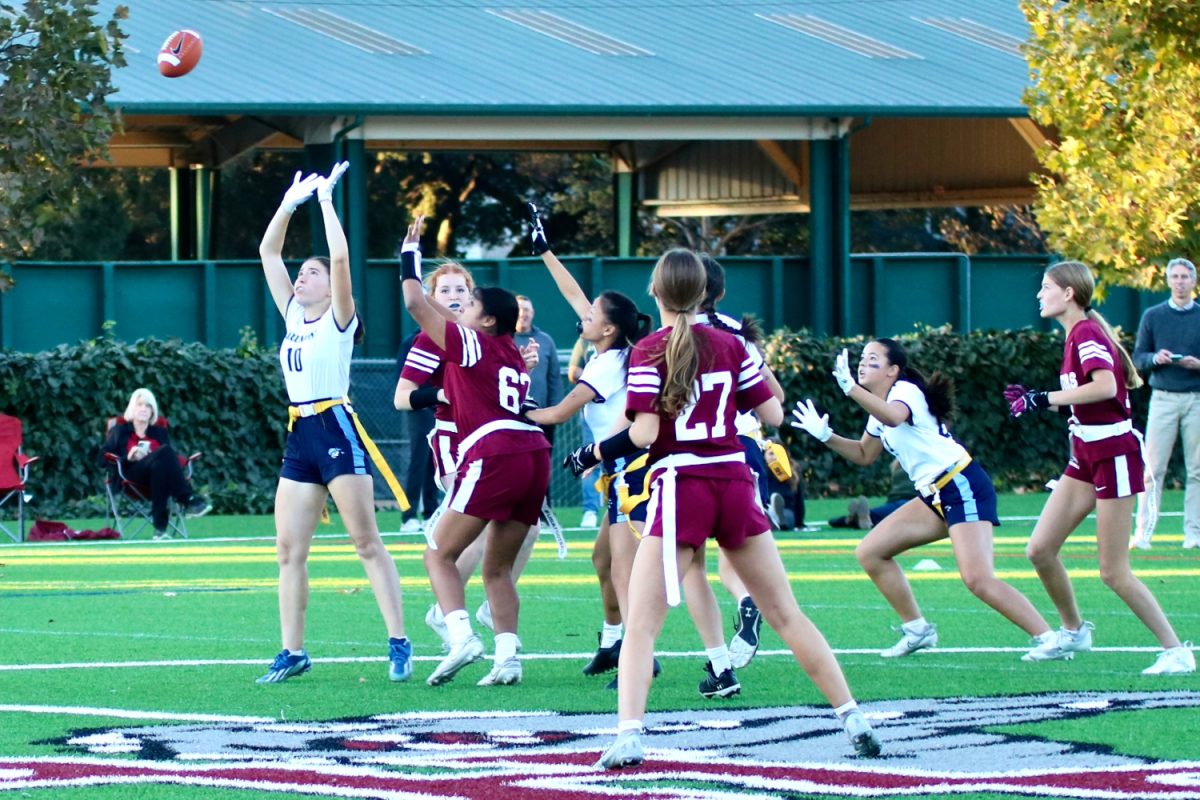 Sophomore Thea Geylani jumps up to intercept the pass. Geylani is new to the program this year. She was instrumental in the Scots pass defense and had several tackles and pass breakups.