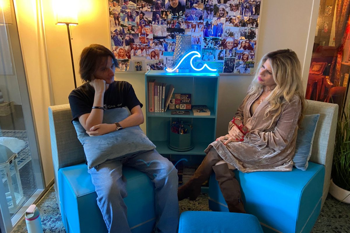 Shelley Bustamante talks with SOS Core Leader Carter Hendrix in the Wellness Center after school. In the Wellness Center, students can lounge on bean bag chairs, find mental health support, and make friends. "People who you never felt you become friends with are sitting with you at a table, and you find out something about them that you can relate to, and it starts a friendship," said Students Offering Support (SOS) coordinator and crisis management counselor Shelley Bustamante. "It's a really cool thing to watch evolve and happen."