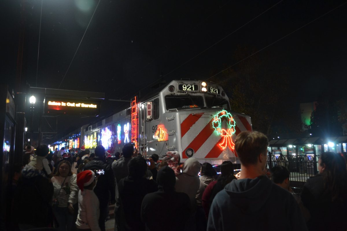 Crowds gather around the Holiday Train at the Redwood City Train Station on Dec. 7. The Holiday Train visits the Bay Area annually decorated with festive lights and colors. 