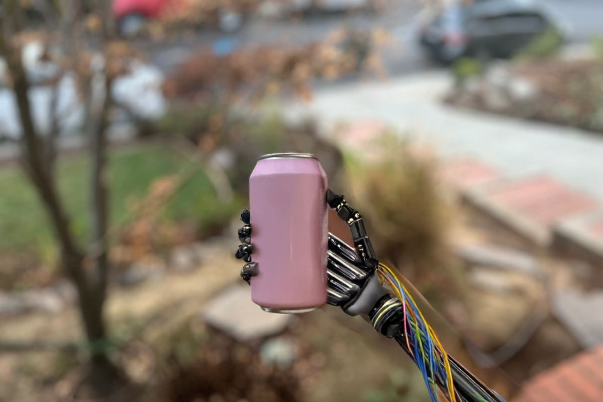 A robot hand holds a can of soda. "I think if you're trying to have fun or get into cooking, and you're just like me and it's a hobby, then finding recipes is an absolutely wonderful way to use AI. It is an easier way to get into cooking," said Emmett Rennich, a Carlmont sophomore.