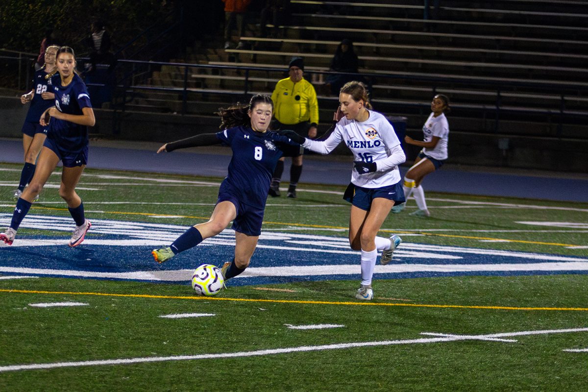 Scots sophomore Lia Frazita dives in for a tackle against a Knights midfielder. Frazita played with intensity throughout the game. She made many important attacking and defensive plays, both winning back and carrying the ball forward.