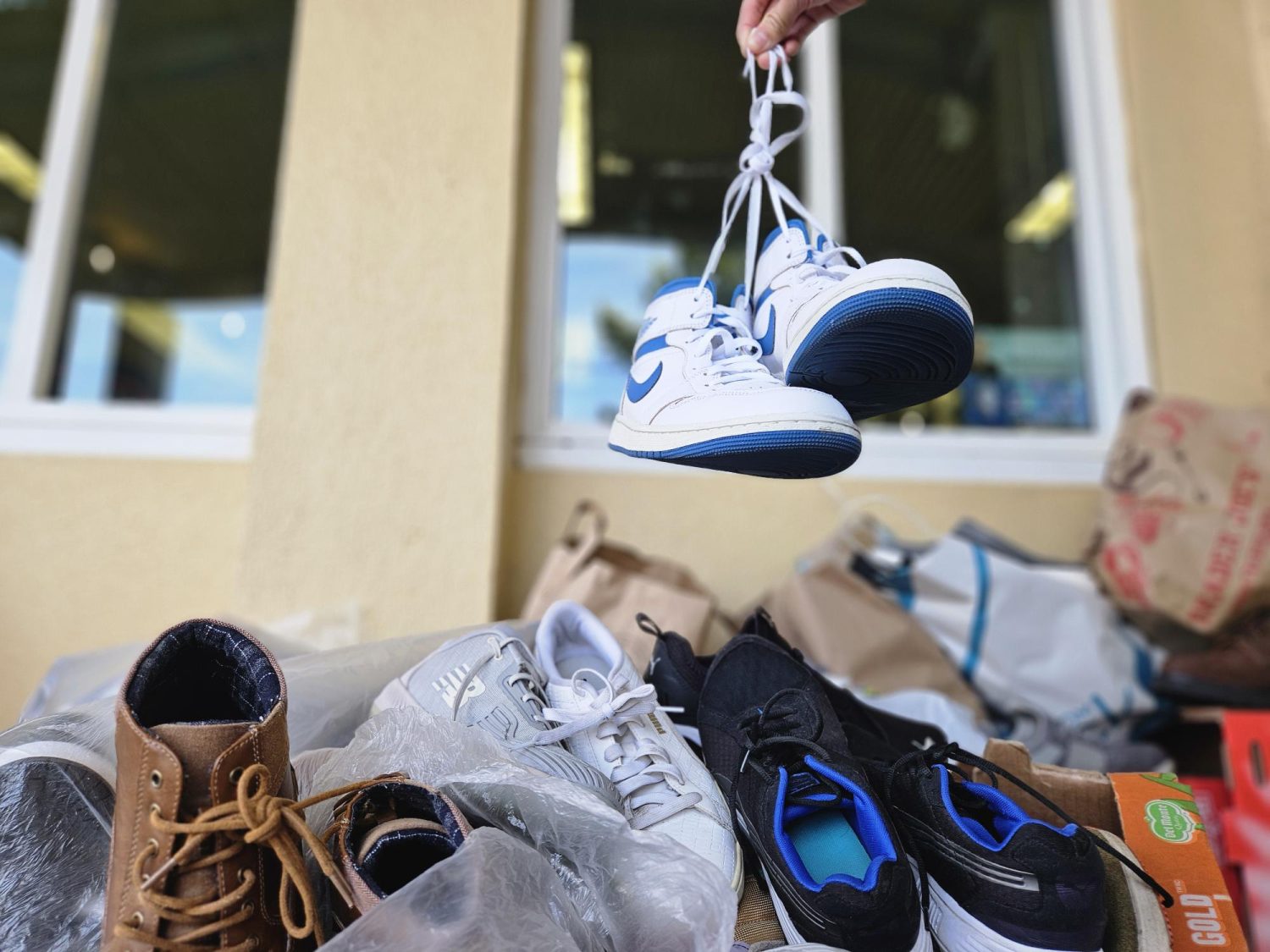 Shoes of wearable condition are dropped off in the overflowing shoe xrive donation box outside of the ASB room to contribute to the charity.