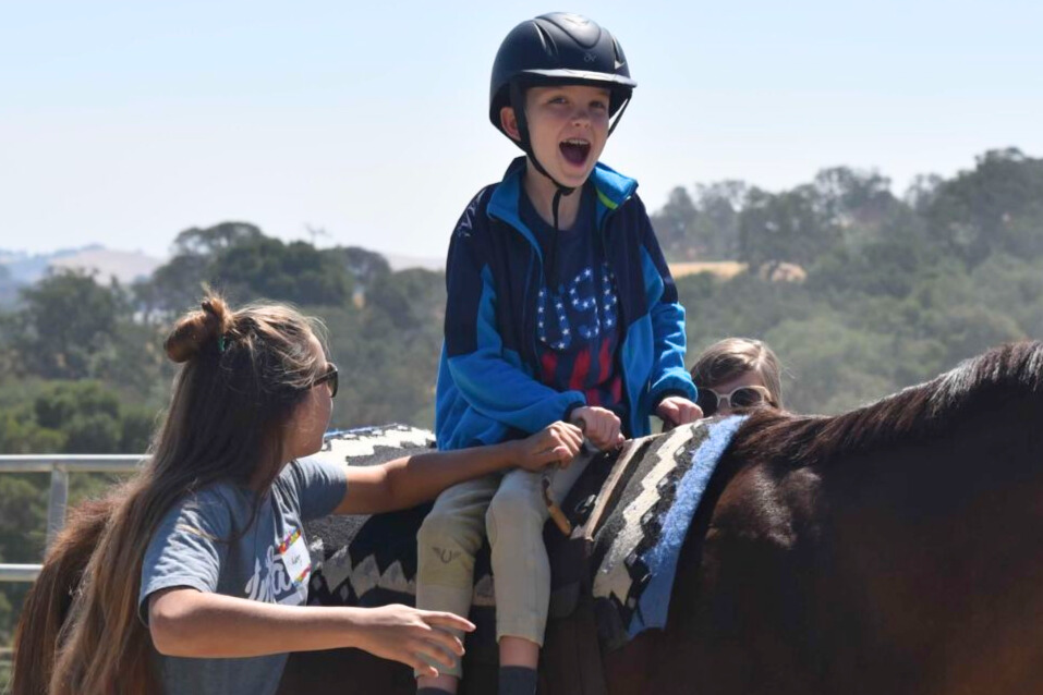 A young rider with a neuromuscular disability experiences the freedom and excitement of theraputic horseback riding at BOK Ranch.